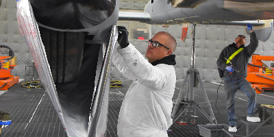man inspecting airplane
