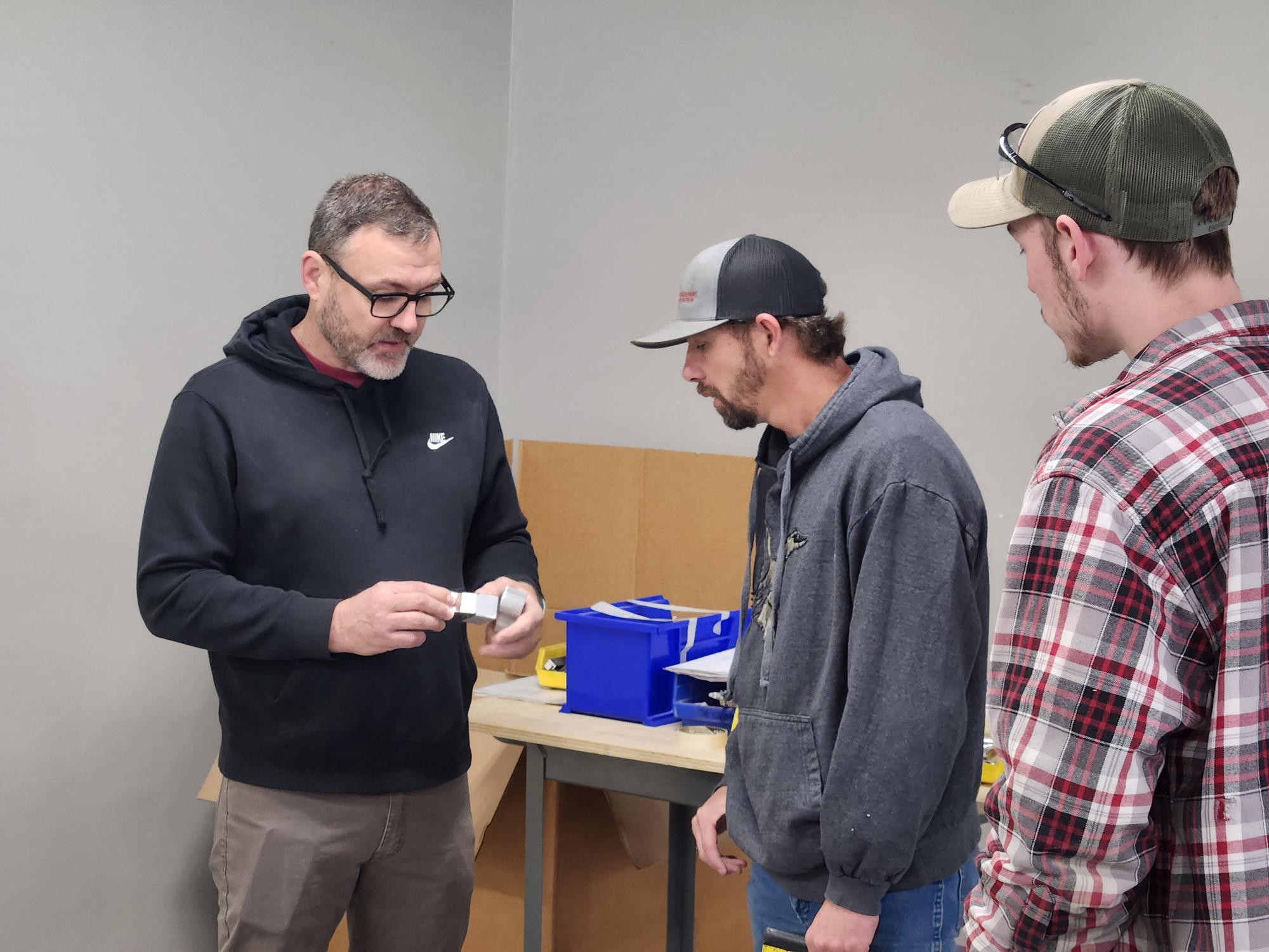 training session taking place in a workshop or manufacturing environment