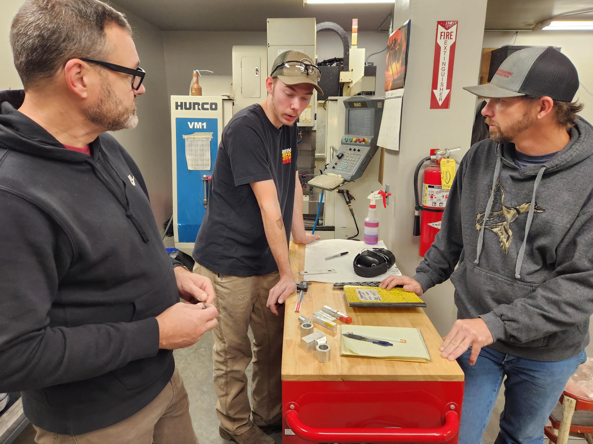 training session taking place in a workshop or manufacturing environment