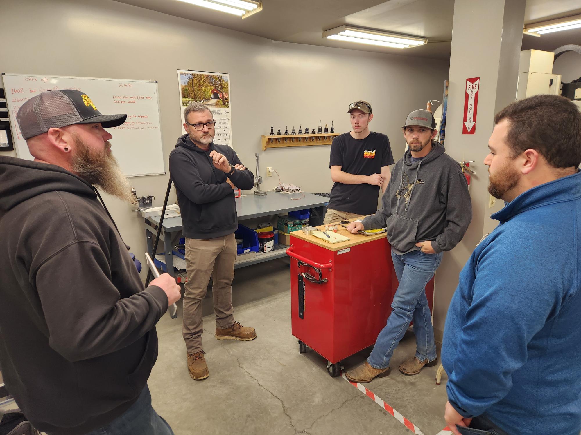 training session taking place in a workshop or manufacturing environment