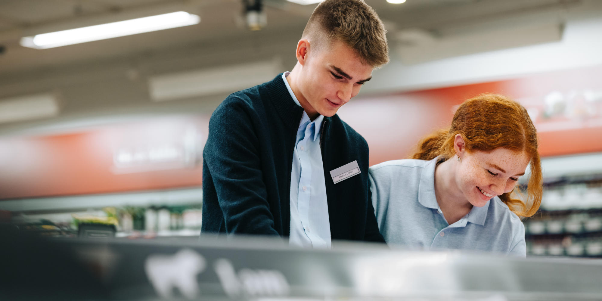 Image of two young workers in a grocery store